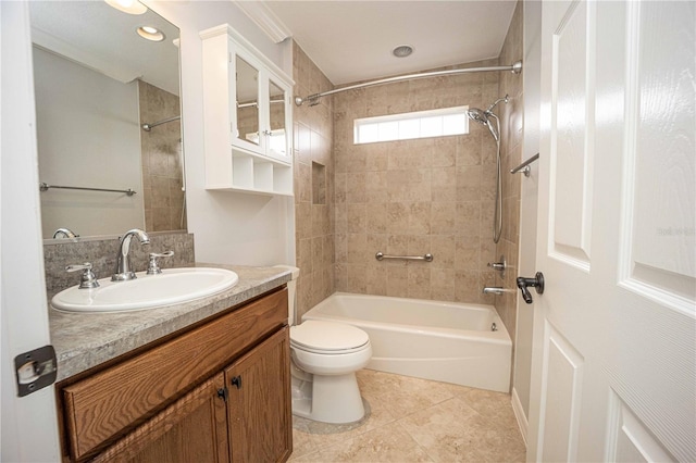 full bathroom featuring tiled shower / bath combo, tile floors, large vanity, and toilet