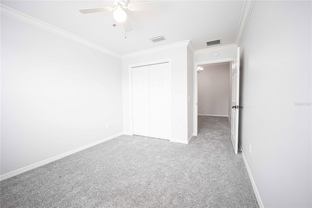 unfurnished bedroom with ceiling fan, a closet, light colored carpet, and ornamental molding