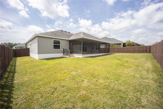 rear view of house with a patio area and a lawn