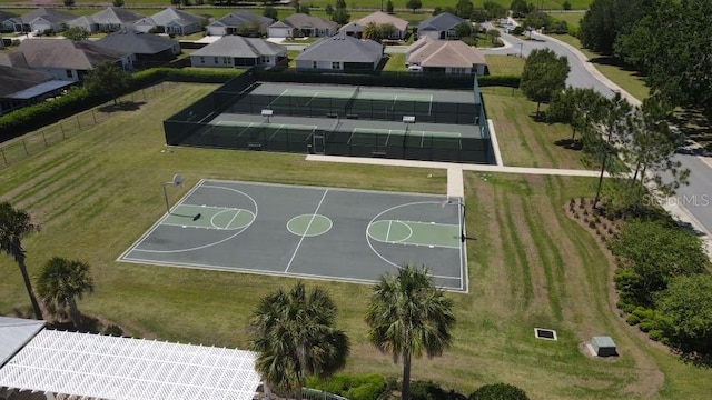 view of basketball court with a lawn