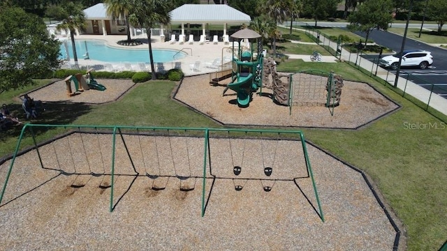 view of home's community with a lawn, a playground, and a pool