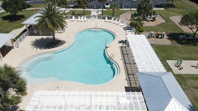 view of swimming pool featuring a patio area and a lawn