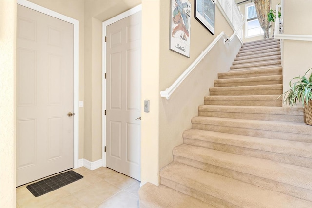 stairs with light tile floors