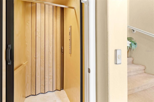 interior space with tile floors and elevator