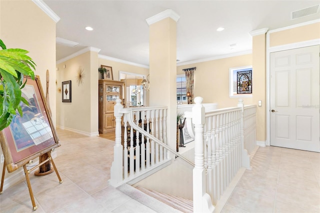 corridor featuring ornamental molding and light tile floors