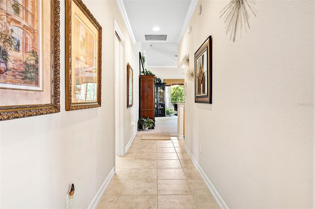 corridor with ornamental molding and light tile floors