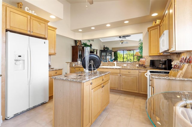 kitchen with ceiling fan, white appliances, light tile flooring, a kitchen island, and backsplash