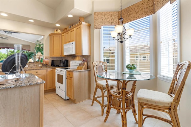 kitchen with white appliances, light stone countertops, backsplash, and light tile flooring