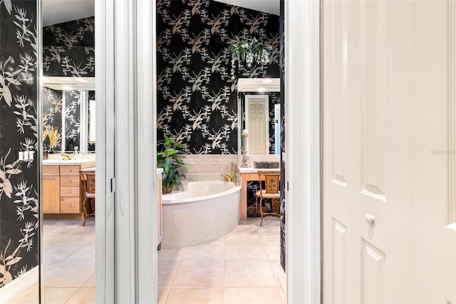 bathroom with a bath, tile flooring, and large vanity