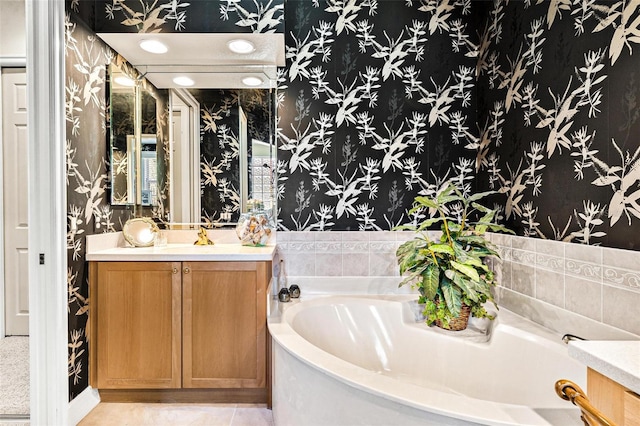 bathroom featuring a washtub, vanity, and tile flooring