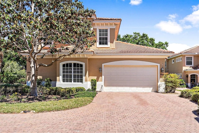 mediterranean / spanish house featuring a garage