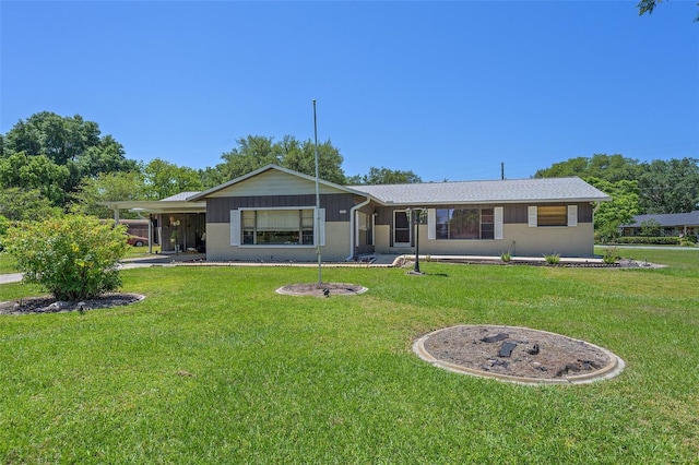 rear view of house featuring a lawn