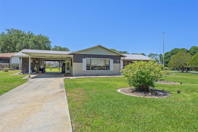 view of front facade with a carport and a front lawn