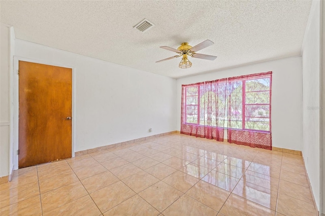 unfurnished room featuring ceiling fan, a textured ceiling, and light tile flooring