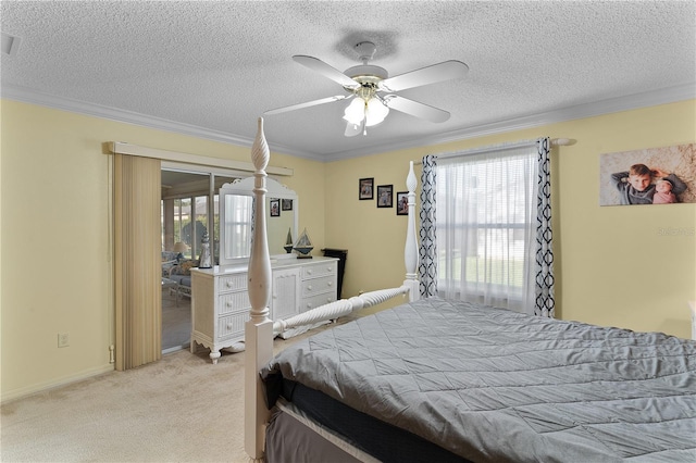 bedroom with light carpet, ceiling fan, multiple windows, and a textured ceiling