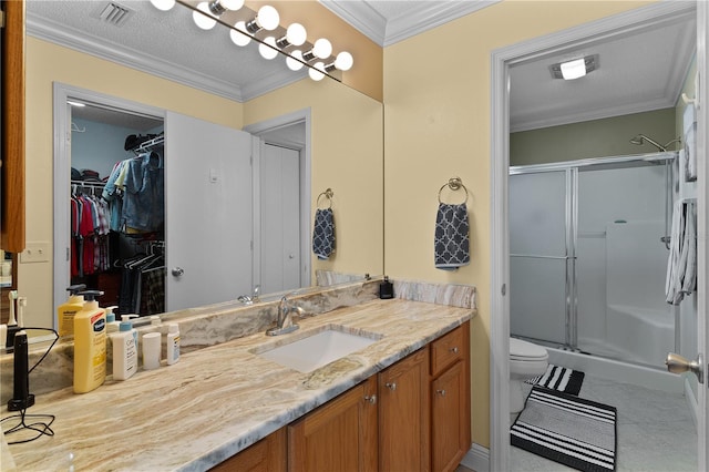 bathroom with toilet, tile flooring, a shower with shower door, vanity, and ornamental molding