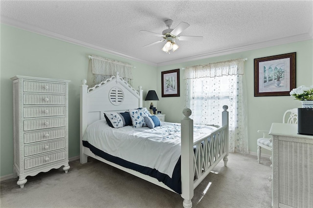 bedroom with ceiling fan, crown molding, dark colored carpet, and a textured ceiling