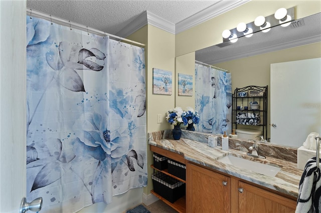 bathroom featuring crown molding, a textured ceiling, and vanity