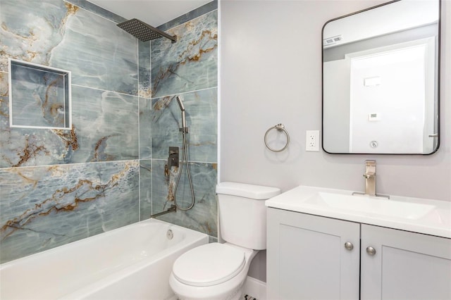 full bathroom with vanity, tiled shower / bath, and toilet