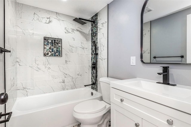 full bathroom with vanity, tiled shower / bath combo, and toilet