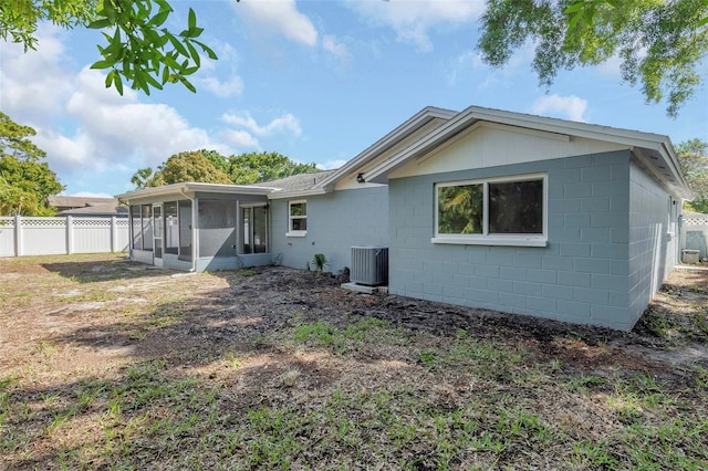 back of property with a sunroom and cooling unit