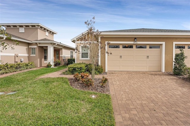 view of front of property featuring a front yard and a garage