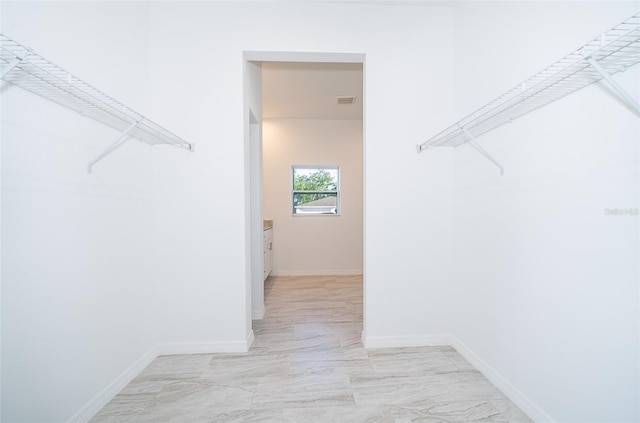 spacious closet featuring light tile flooring