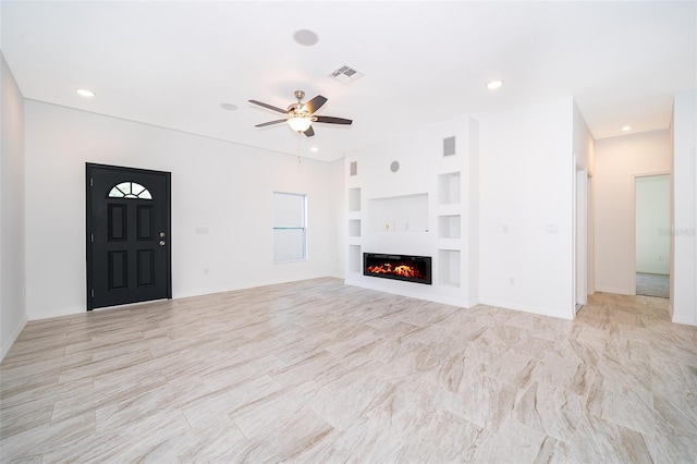 unfurnished living room with ceiling fan, light tile floors, and built in shelves