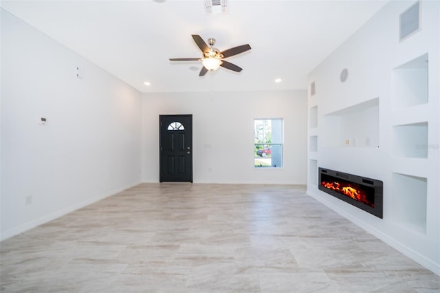 unfurnished living room with built in shelves and ceiling fan