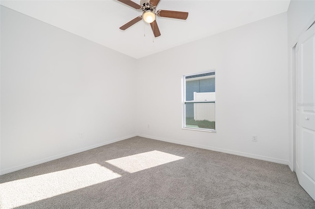 carpeted empty room featuring ceiling fan