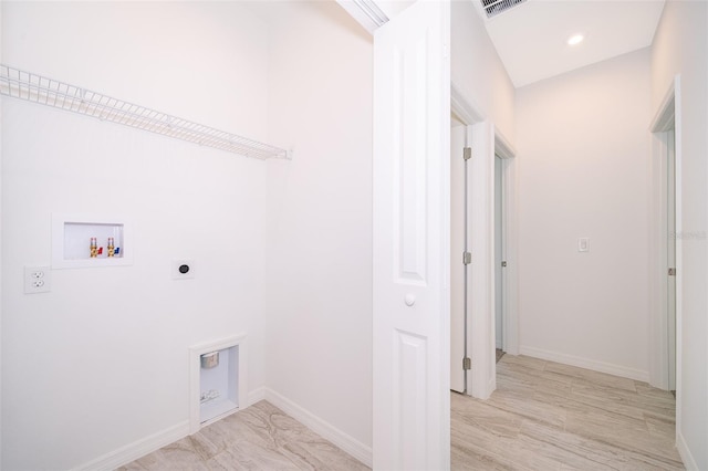 clothes washing area with light wood-type flooring, washer hookup, and electric dryer hookup