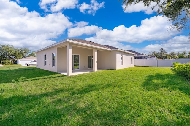 rear view of property with a lawn