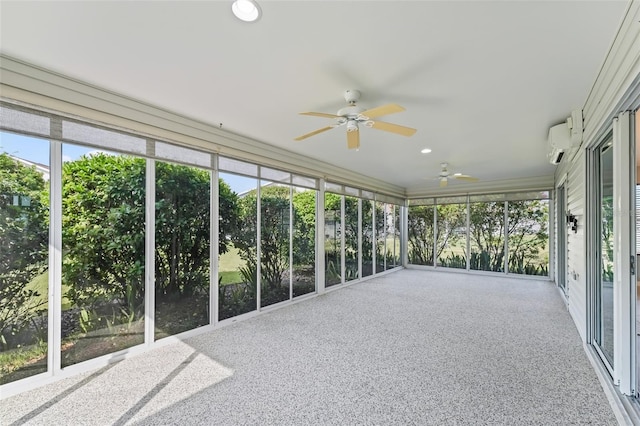 unfurnished sunroom featuring a wall mounted air conditioner and ceiling fan