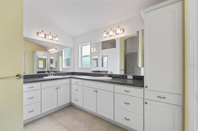 bathroom featuring double vanity, tile flooring, and lofted ceiling