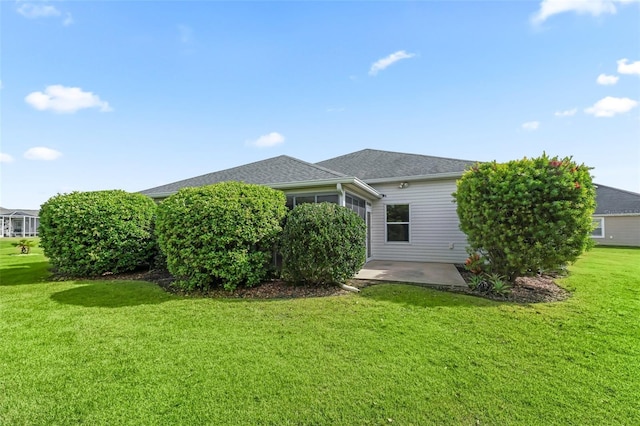 view of home's exterior featuring a patio area and a yard