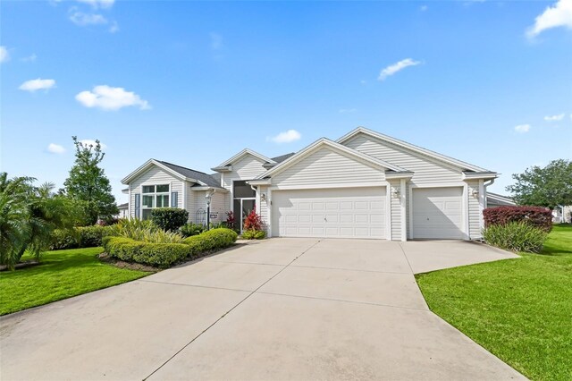 ranch-style house featuring a garage and a front lawn