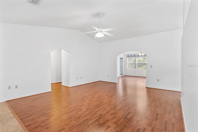 spare room featuring hardwood / wood-style floors, ceiling fan, and lofted ceiling