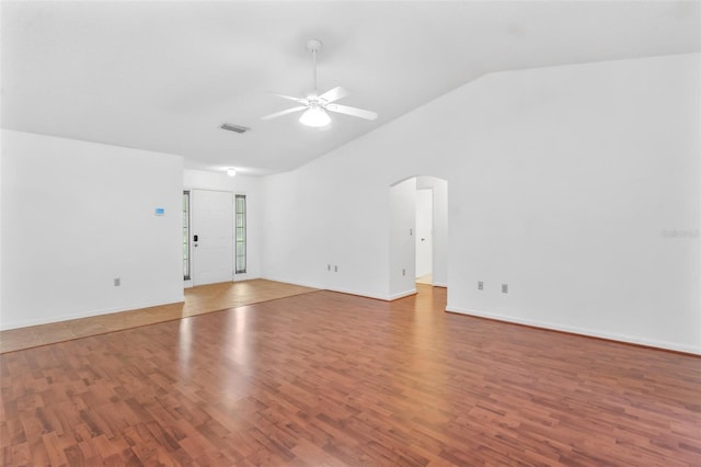 spare room with lofted ceiling, ceiling fan, and wood-type flooring