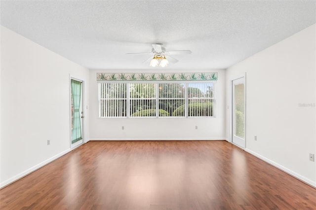 empty room with a textured ceiling, hardwood / wood-style flooring, and ceiling fan