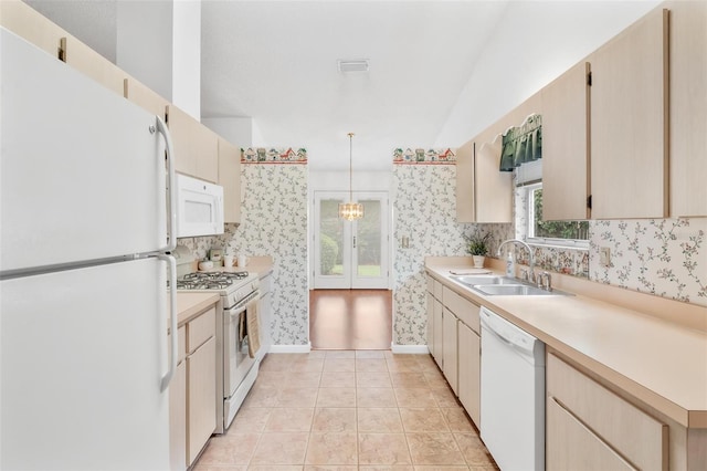 kitchen featuring sink, a chandelier, pendant lighting, white appliances, and light tile patterned floors