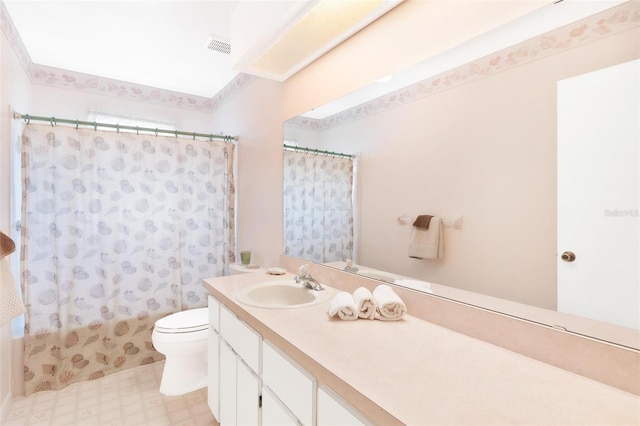 full bathroom featuring vanity, shower / tub combo, and toilet