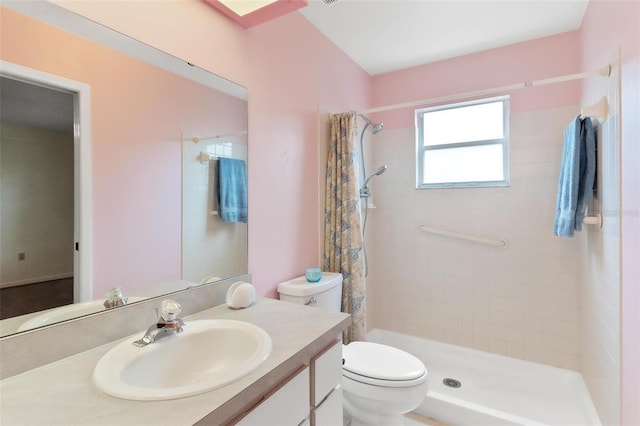 bathroom featuring curtained shower, vanity, and toilet