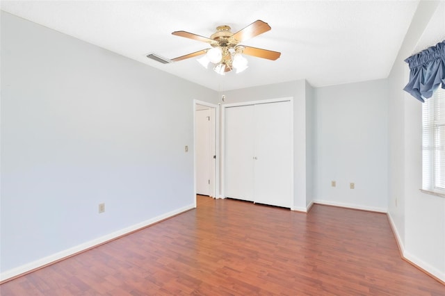 empty room featuring ceiling fan and dark wood-type flooring