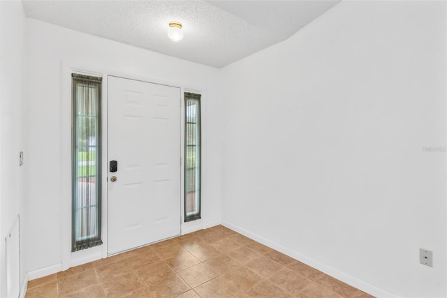 entrance foyer featuring a textured ceiling