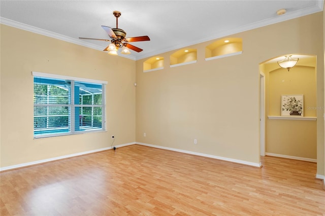 spare room with light hardwood / wood-style floors, crown molding, and ceiling fan