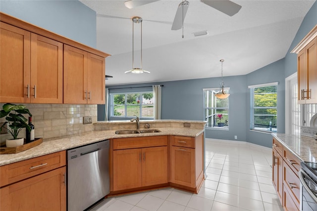 kitchen with sink, ceiling fan, a wealth of natural light, light tile floors, and stainless steel dishwasher