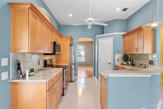 kitchen with backsplash, ceiling fan, stainless steel appliances, and light tile floors