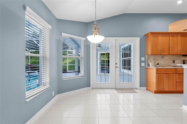 interior space featuring french doors, vaulted ceiling, and light tile floors