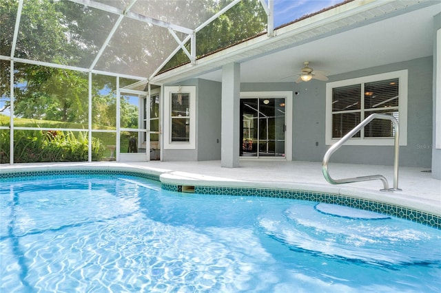 view of pool with a patio, ceiling fan, and glass enclosure