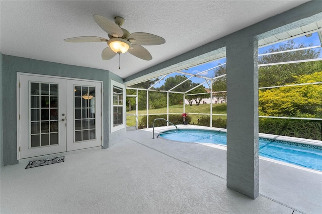 view of swimming pool featuring ceiling fan, a lanai, and a patio